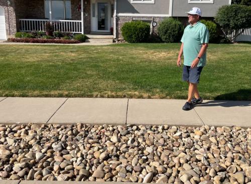 Washington Terrace Mayor Mark Allen stands outside his home on Tuesday, July 12, 2022, in front of the park strip that he converted from grass to rocks. He tapped into the Weber Basin Water Conservancy District's Flip Your Strip program to complete the changeover, meant to help reduce the amount of water he uses for irrigation.